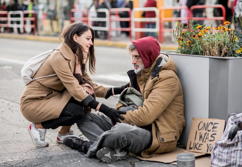 Woman Tending to Homeless Man